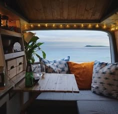 the inside of a camper with lights strung over it