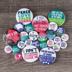 a pile of buttons with different sayings on them