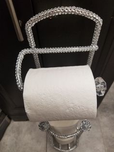 a roll of toilet paper sitting on top of a metal holder