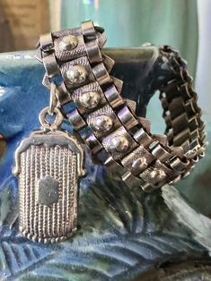 This is a lovely, slinky, gothic style bracelet with the cutest antique purse charm. I love the textured finish of this bracelet, in combination of the smooth ball highlights, gives it a very stylish look. The purse charm is also great, with the detailing imitating the silver mesh purses of the period, every detail from the clip on the top to the little fringe on the bottom. Size: The wearable length of this bracelet measures 1.8cms x 1.4cms wide.  The charm measures 3.4cms long. Condition: Excellent original condition. Hallmarks: French silver mark on one end of the chain and silver and makers mark on the purse charm. Please read this boring but important information before making your purchase. These purchase terms & conditions apply to this transaction. * This listing is for the antique Antique Metal Bracelet With Charms, Victorian Bracelets With Vintage Charm As Gift, Victorian Style Bracelet With Vintage Charm For Gift, Antique Metal Bracelets With Vintage Charm, Victorian Engraved Metal Bracelets, Antique Engraved Chain Bracelet Gift, Antique Purse, Antique Bracelets, Silver Flats