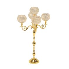 a golden candelabra with three crystal balls on it