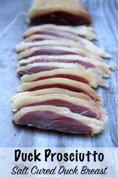 sliced duck prosciutto sitting on top of a piece of parchmented paper