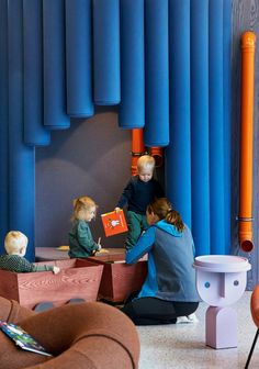 two children and an adult are playing with toys