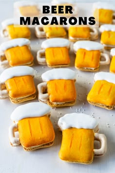 mini beer mugs with white frosting on them and the words beer macarons