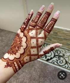 a woman's hand with hennap on it, showing the intricate design