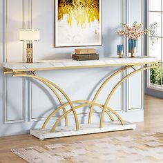 a console table with marble top and gold metal frame, in a living room setting