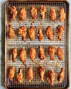 baked chicken wings on a baking tray ready to be cooked in the oven or used as an appetizer