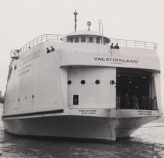 an old photo of a large boat in the water with people standing on it's deck