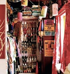 a store filled with lots of different types of shoes and scarves hanging from the ceiling