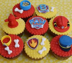 some cupcakes are decorated with cartoon characters