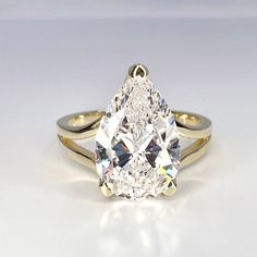 "Pear Shaped Solitaire Engagement Ring Solid Gold, Unique Split Shank Pear Cut Wedding Ring, Pear Shaped Ring, Teardrop Engagement Ring  Re vist our shop: https://etsy.me/3Pzzwpx To see more engagement ring options click here: https://etsy.me/3Xq7mzb For Band options click here: https://etsy.me/3Nm4ZKf -Approximate total carat weight:  3.00ctw diamond equivalent  -Center Stone Size:  12x8mm approx. 3.00ct diamond equivalent -Gem Type:  simulated diamond -Stone Shape:  Pear -Stone Clarity: VVS1 - Luxury Yellow Gold Pear-shaped Wedding And Engagement Rings, Luxury Pear-shaped Rose Cut Diamond Wedding Ring, Luxury Pear-shaped Solitaire Jewelry, D Shaped Rings, Luxury Solitaire Pear-shaped Jewelry, Luxury Pear Shaped Rings With Prong Setting, Double Diamond Engagement Ring Split Shank, Pear Engagement Ring With Shield Side Stones, Luxury Pear-shaped Solitaire Ring