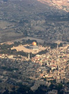 an aerial view of a city and its surrounding area, including the dome of the rock