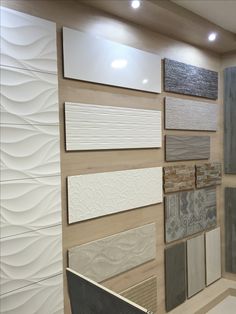 a wall with many different types of tiles and floor coverings on it's sides