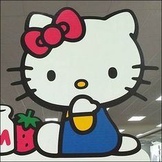 an image of a hello kitty sign on the wall in front of a store window