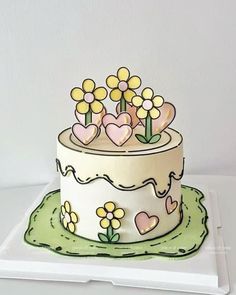 A real cake that looks like a drawing. Green at the bottom to mimic grass and a white icing base with yellow flowers and pink hearts on top and the side. Also yellow icing on the top of the cake and going down the edges slightly. Kue Fondant, Tårta Design, Cartoon Birthday Cake, Unique Birthday Cakes, Simple Cake Designs, Funny Birthday Cakes, Mini Cakes Birthday, Cartoon Cake, Creative Birthday Cakes