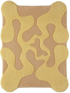 a beige and yellow rug with wavy shapes on the bottom, in front of a white background