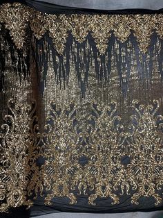 Angelica GOLD Curlicues and Leaves Sequins on BLACK Mesh Lace Fabric by the Yard - 10132Content: 100% polyesterStretch: 4-wayWidth: 56 to 59 inchesEdge: StraightUses: Wedding/evening gowns, formal wear, dresses, tops, skirts, decorations, costumes, apparel accents/appliqué, crafts, etc.*********************************************************************************************DISCLAIMER: Expedited shipping options do not apply to 5, 10, 50 and 100 yard options.Sample/Swatch: 4x2 inches for $4.9 Glamorous Gold Sequin Fabric For Festive Season, Glamorous Gold Sequin Fabric For Festive, Gold Sequin Fabric For Festive Celebrations, Gold Sequin Fabric With Glitter Print For Glamorous Looks, Festive Gold Sequin Fabric With Gold Embroidery, Fitted Gold Fabric With Intricate Embroidery, Gold Sequin Fabric With Glitter Print For Party, Festive Gold Sequin Fabric, Gold Embroidered Lace Fabric