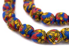 a multicolored bead necklace is displayed on a white surface with red, yellow and blue beads