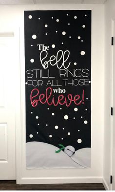 the bell still rings for all those who believe christmas door hanger with snow falling on it