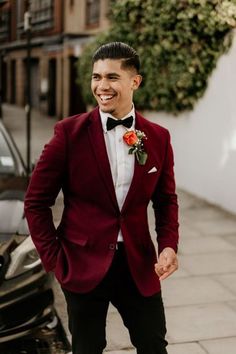 a man in a red suit and bow tie