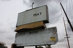 an old sign that says pray on top of it