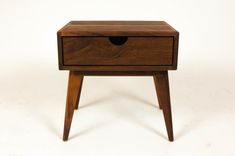 a small wooden table with one drawer open