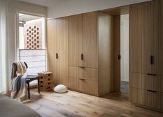 a bedroom with wooden closets and white walls