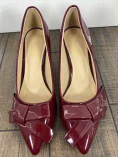 Beautiful patent leather heels in dark red, cute side bow. Rare name brand. Plastic protectors still on bottom sole. Never worn outside. Please view pictures and ask questions prior to purchase. All sales final. Smoke and cat free home not dog free. Shipped with USPS Priority Mail. Burgundy Closed Toe Synthetic Heels, Vintage Formal Heels In Synthetic Material, Vintage Synthetic Heels For Formal Occasions, Red Heels, View Pictures, Patent Leather Heels, Leather Shoes Woman, Leather Heels, Dark Red