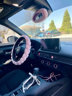 the interior of a car with a steering wheel cover and other accessories in front of it