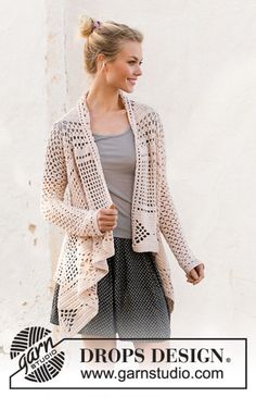 a woman is walking down the street wearing a cardigan