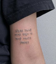 someone with a tattoo on their arm that says speak your mind even if you voice shakes