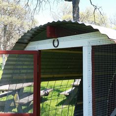 a chicken coop with two chickens in it