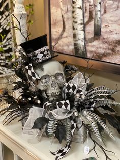 a skull is sitting on top of a mantle with black and white decorations around it