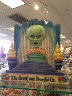 an alien head is on top of a toy display case in a toyshope