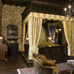 a bedroom with a four poster bed and stone walls