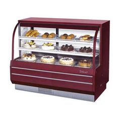 a display case filled with lots of different types of cakes and pastries in it