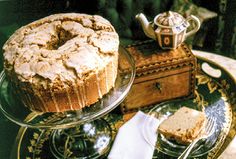 a cake on a plate next to a tea pot