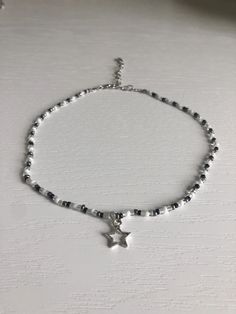 Black and white beaded choker with silver star charm. Necklace length can be adjusted from 12.5-n-15.5in. If you would like the choker to be longer, please message me. Beads are czech glass size 10/0 seed beads. Super cute and lightweight. Necklace care: avoid wearing in water or to sleep to keep necklace in the best shape. Store in a cool, dry place. Overtime, the clasp and chain may begin tarnish. Cheap Black Necklaces With Star Charm, Star Girl Necklace, Silver Star Choker, Beaded Necklace Seed Beads, Star Style Aesthetic, Affordable Star-shaped Beaded Necklace, White Necklace Beads, Black And White Beaded Jewelry, Cute Necklaces To Make With Beads