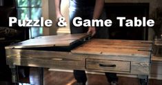 a person standing next to a wooden table with drawers on it and the words puzzle & game table