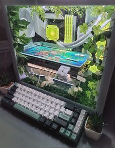 a computer keyboard sitting on top of a desk next to a plant and potted plants