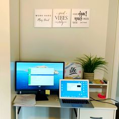 two computer monitors sitting on top of a desk