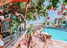 an outdoor dining area next to a swimming pool