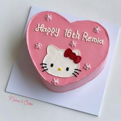 a heart shaped cake with hello kitty on it's side and the words happy 16th rama written in pink frosting