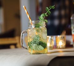 a mason jar filled with lemonade and mint