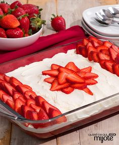 there is a cake with strawberries on it and two bowls of strawberries in the background