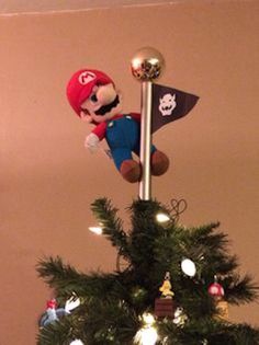 a christmas tree decorated with mario and his pirate flag, is shown in this image