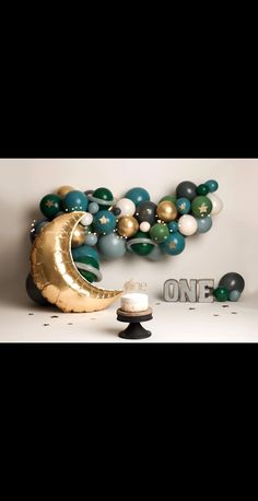 a balloon arch and some balloons in the shape of a crescent on a white background