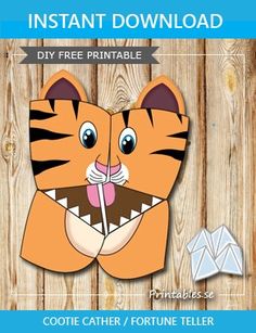 a paper cutout of a tiger with its mouth open and teeth wide open, on a wooden background