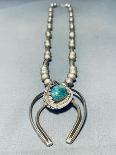 MAKE US AN OFFER BY CLICKING THE "MESSAGE SELLER" Button- This is a fascinating vintage Navajo single stone silver bead necklace. This incredible necklace contains a bottom double shank silver naja pendant that measures around 2-1/4" X 1-3/4". Located on the naja is a superior large dome shaped Royston turquoise stone with accenting raindrops and a detailed silver leaf. Running up the necklace are amazing handmade round silver beads with accenting silver torpedo beads and a traditional silver clasp.  Sterling silver. Cir. Mid century + . The length of the necklace measures around 30". Sturdy 48 grams. Make Us an Offer- Due to the high demand of our items, many pieces sell quite fast. The most frequent email we receive are from buyers who waited too long to make us an offer and suddenly los Naja Pendant, Silver Bead Necklace, Navajo Turquoise, Royston Turquoise, Cameo Necklace, Single Stone, Vintage Navajo, Silver Bead, Silver Leaf