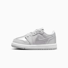 Jordan 1 Retro Low "Silver"Baby/Toddler ShoesEvery Jordan Retro is a classic sneaker done up in new colors and textures for a fresh look. With metallic silver leather, this iteration gives little feet stand-out style. Plus, premium materials and accents keep the look modern and on point. Real and synthetic leather in the upper helps add durability and structure.Foam sockliner helps cushion little feet.Rubber in the outsole helps give kiddos the traction they need. More Details Classic laces The Tops And Bottoms, Kids Jordans, Air Jordan 1 Retro, Classic Sneakers, Jordan 1 Retro, Jordan Retro, Toddler Shoes, Air Jordan 1, White Style